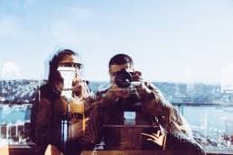 couple taking selfie in reflection, blurry but still better than nothing