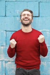 Cheering because winning; Man clenching fists with joy