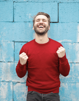 Cheering because winning; Man clenching fists with joy